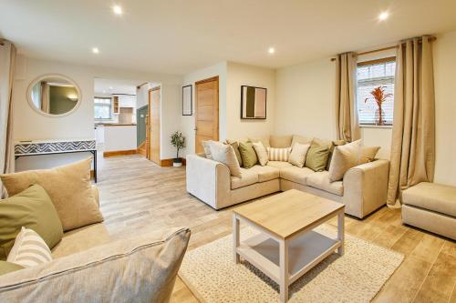 a living room with two couches and a table at Host & Stay - Fawcett Cottage in Tollerton