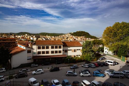 a parking lot with cars parked in front of a city at Dimora Giulia in Campobasso