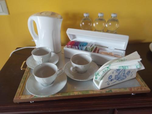 a tray with cups and saucers on a table at Assisi il Panorama in Petrignano
