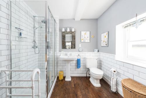 a bathroom with a toilet and a sink at Stunning & spacious Georgian town house in St Neots town centre with parking in Saint Neots