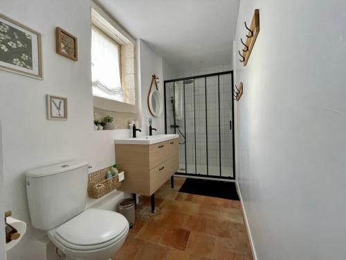 a bathroom with a toilet and a sink at Les Régniers - 2 gîtes pour partir ensemble in Eynesse