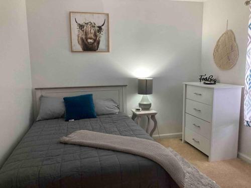 a bedroom with a bed with a picture of a bull on the wall at Midtown Harrisburg Townhouse in Harrisburg