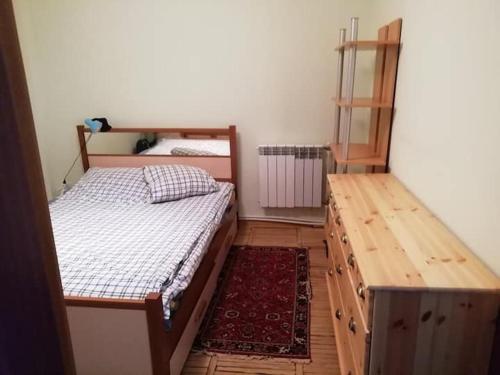 a bedroom with two twin beds and a wooden desk at Art home 2 in Vagharshapat