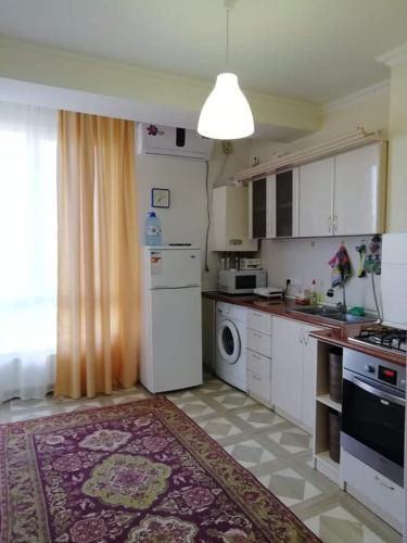a kitchen with a white refrigerator and a dishwasher at Art home 2 in Vagharshapat