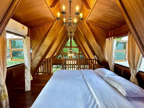 - un grand lit dans une chambre avec plafond dans l'établissement Ban Kaew Mo Ra Glamping & Restaurant, à Pang Mapha