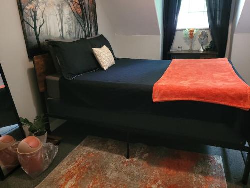 sypialnia z czarnym łóżkiem i czerwonym kocem w obiekcie Cozy Delightful Private Studio near Rhodes College w mieście Memphis