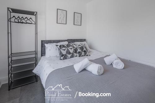 a bedroom with a large bed with pillows at Two Bed House At Primal Estates Short Lets in Brighton in Brighton & Hove