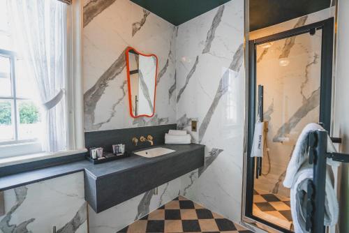 a bathroom with a sink and a shower at Hunton Park Hotel in Kings Langley