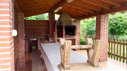 an outdoor patio with a brick building with a fireplace at LA LLANADA in Cangas de Onís