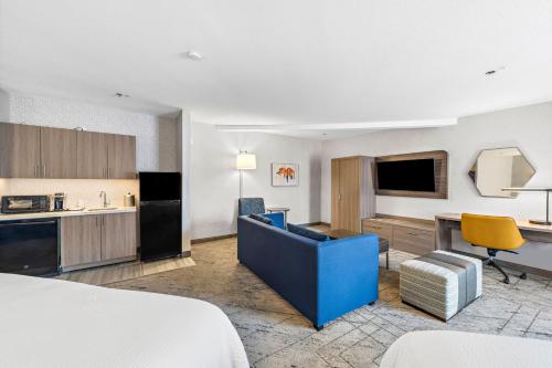a hotel room with a bed and a kitchen at Holiday Inn Express La Mesa Near SDSU, an IHG Hotel in La Mesa