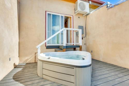 a bath tub sitting in front of a window at La Colina El Prado Condo with Hot Tub, Deck and Views in El Prado