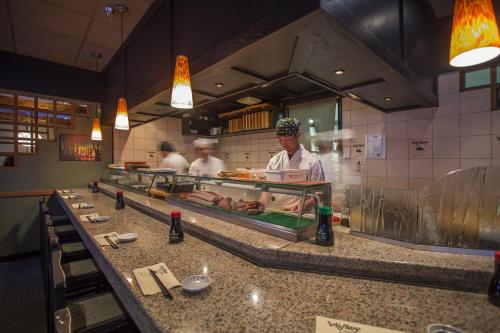 a chef preparing food in a restaurant kitchen at Sundial Hotel in Whistler