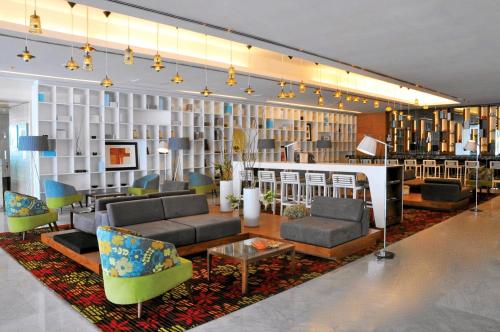 a lobby with couches and chairs on a rug at Emporio Veracruz in Veracruz