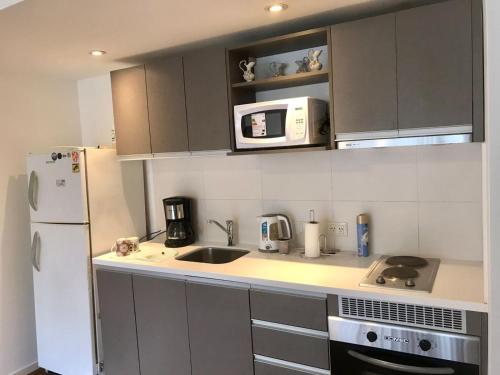 a kitchen with a white refrigerator and a sink at Departamento en Ushuaia in Ushuaia