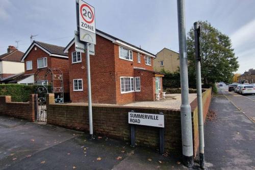 una señal de no estacionamiento frente a una casa de ladrillo en Luxury 3 Bed Detached House, en Farsley