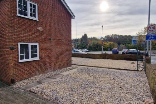 a brick building with a window on the side of it at Luxury 3 Bed Detached House in Farsley