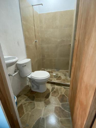 a bathroom with a toilet and a sink at Casa Santorini in Cartagena de Indias