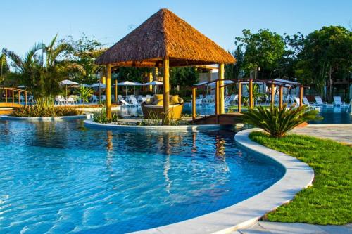 a swimming pool with a gazebo in a resort at Iloa Residence Apt Premium -Quarto e sala climatizado in Barra de São Miguel