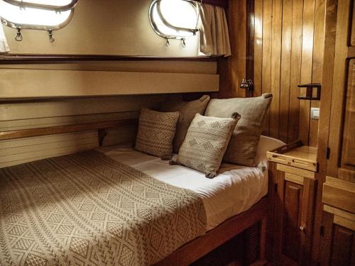 a bed in the back of a boat at Wooden Boat- La Goletta in Barcelona