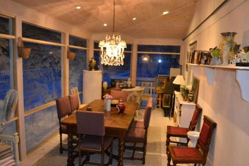 a dining room with a table and chairs and a chandelier at Havsnära Motorbåt 12 Cyklar 18+Beds VedBastu Hav! in Djurhamn