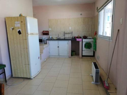 Il comprend une cuisine équipée d'un réfrigérateur blanc. dans l'établissement Departamento de temporada para 6 personas, à Mar de Ajó