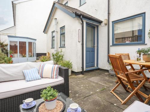 a patio with a couch and a table at Wingelock in Rhosneigr