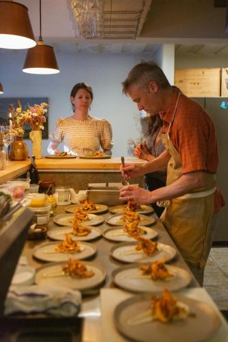 a man and woman preparing food in a kitchen at RubyJune Inn in White Salmon