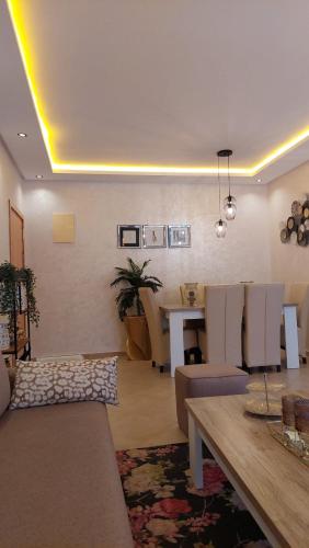 a living room with a couch and a table at Taghazout "luxe residence Tafoult" 3 pools and aquapark in Taghazout