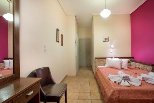 a hotel room with two beds and a mirror at Aktaion Hotel in Monemvasia