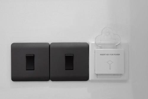 two electrical plugs with a case on a white background at D Plus B&B Negombo in Negombo