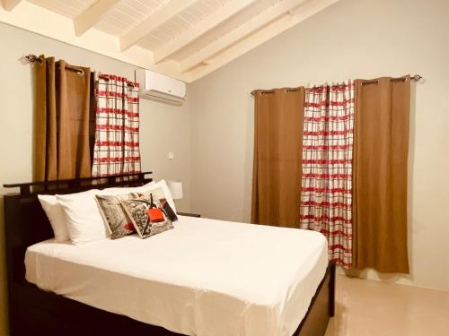 a bedroom with a large white bed with curtains at Jhadano 3br Pool & Gym Free Shuttle Washer, Dryer in Florence Hall