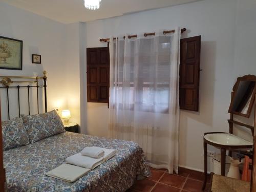 a bedroom with a bed with two towels on it at El Humilladero in Mogarraz