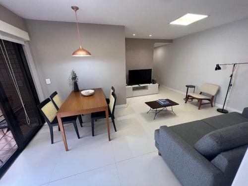a living room with a couch and a table at Ipanema Flat - Vieira Souto 500 in Rio de Janeiro