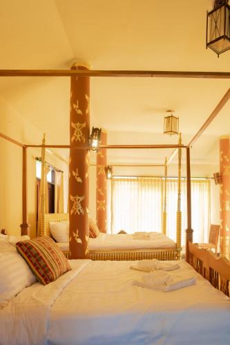 a bedroom with two beds in a room at Baan Tawai Lanna Resort in Hang Dong