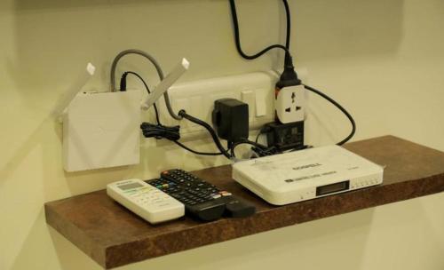 a counter top with a phone and a remote control at Mokalbaug Beach Resort in Nagaon