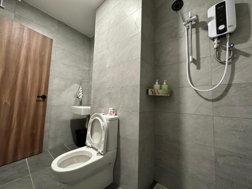 a bathroom with a toilet and a shower at Wanderlust Homes @ Armadale Residence in Kuching