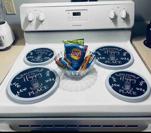 a stove top with three plates and a bowl of chips at Cozy up with me! Longer stays! Free parking in Troy