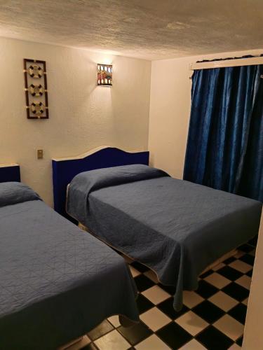 Un ou plusieurs lits dans un hébergement de l'établissement Vacacional Luna Mar