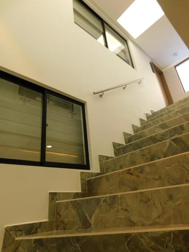 a set of stairs with a large window at HOTEL MX BOGOTA in Bogotá
