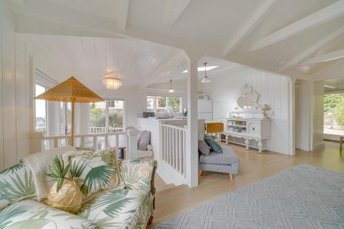 a living room with a couch and a kitchen at Stunning Ventura Cottage with Deck and Ocean View! in Ventura