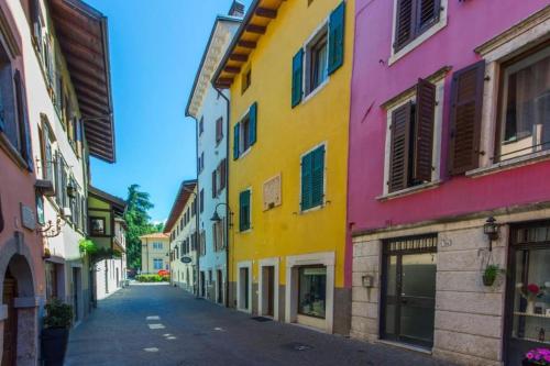 a street in the old town of lille with colorful houses at Monolocale Niki - Holiday Home in Trento