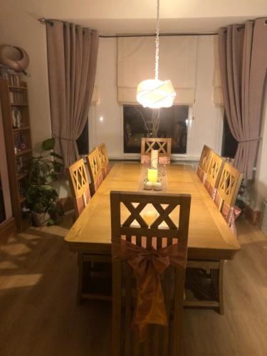 a dining room with a wooden table and chairs at Butterfly House in Blackwood