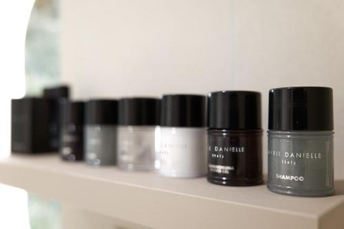 a shelf with several bottles of cosmetics on it at Adriatic Palace Hotel in Lido di Jesolo