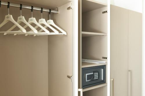 a kitchen with a refrigerator with a microwave at Adriatic Palace Hotel in Lido di Jesolo