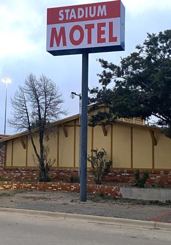 a sign for a station motel in front of a building at Travelodge by Wyndham Lubbock in Lubbock
