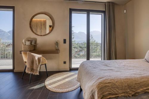 a bedroom with a large bed and a mirror at Maison Gokan in Sévrier