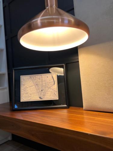 a large light hanging over a counter with a map at ELITE LUXURY BOUTIQUE in Fier