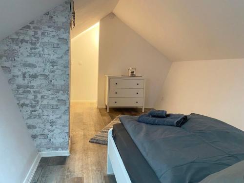 a bedroom with a bed and a dresser in it at Cozy Apartments in Zwickau in Zwickau