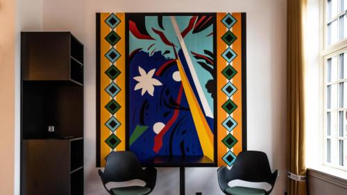 a painting on the wall in a room with two chairs at ART Hotel Dalgas, BW Signature Collection in Brande
