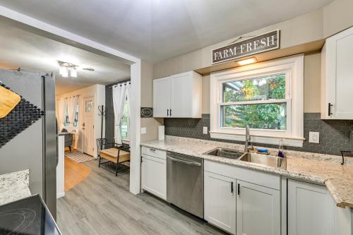 a kitchen with white cabinets and a sink and a window at Dry Ridge Rental Home with Hot Tub and Game Room! in Dry Ridge